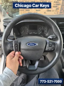 Chicago Car Keys technician holding a newly created key inside a 2025 Ford Transit in Chicago