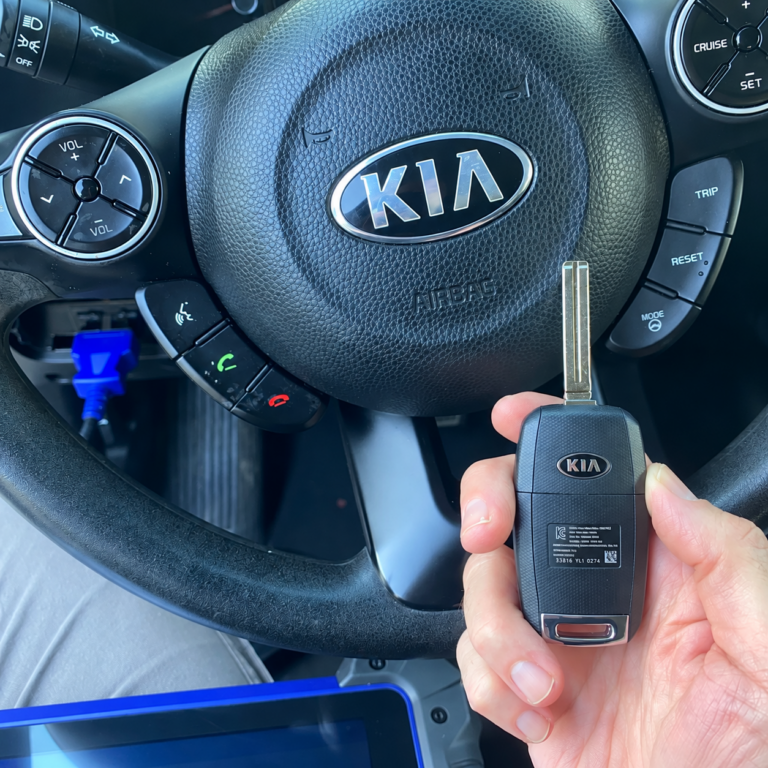 Replacement flip key held inside a 2012 Kia Sportage after an all-keys-lost job in Alsip, Illinois.