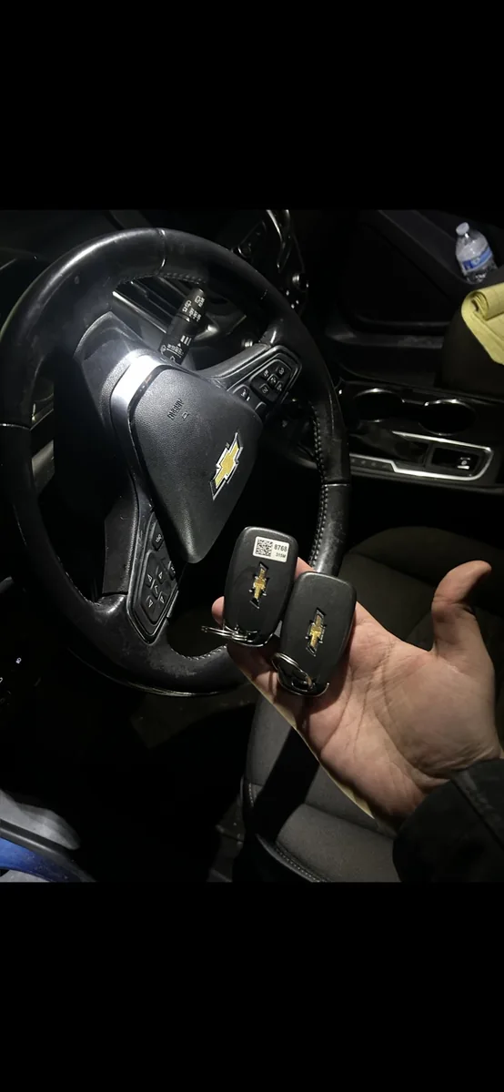 Two replacement Chevrolet smart keys held inside a 2018 Malibu after lost-key programming in Burbank, Illinois.