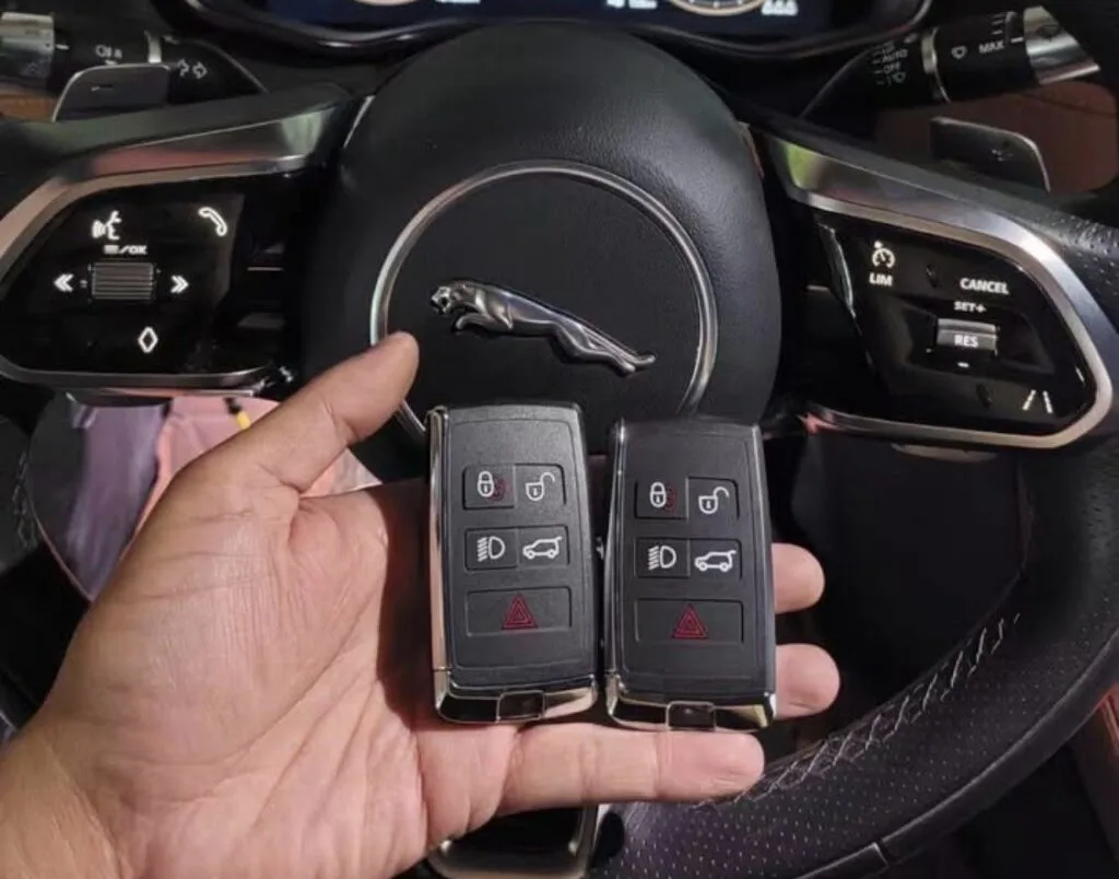Two replacement smart key fobs inside a 2019 Jaguar after an all-keys-lost job in Little Village, Chicago